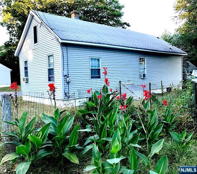1 Cedar Lane Paramus, NJ 07652 - Photo 13 of 13 a flower is in front of a house