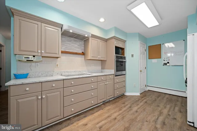 a room with granite countertop cabinets and a sink
