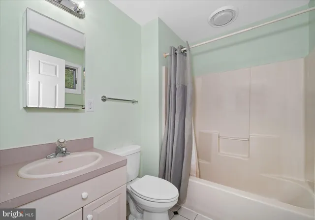 a bathroom with a sink toilet a mirror and shower