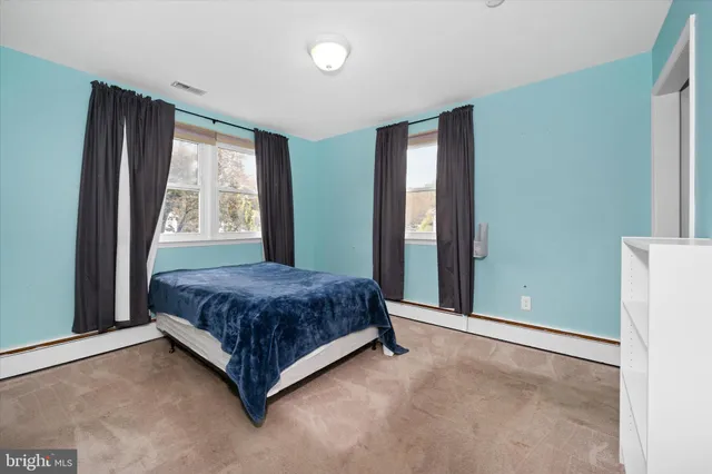 a spacious bedroom with a large bed and a large window