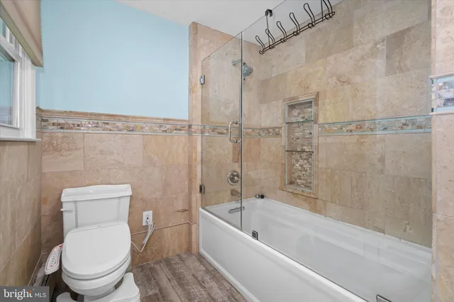 a bathroom with a toilet and a bathtub