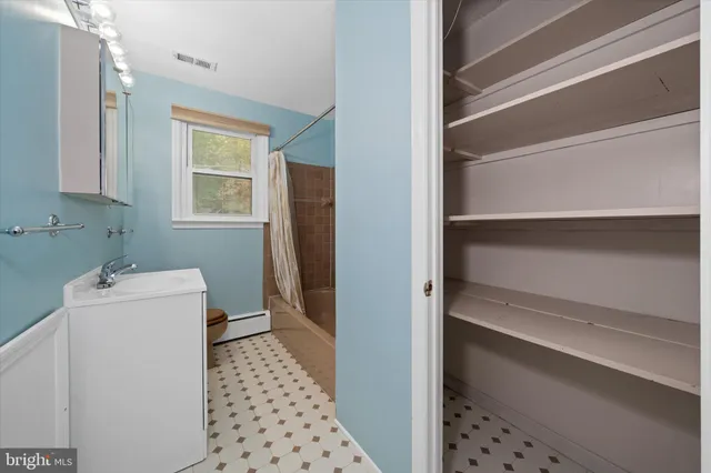 a bathroom with a bathtub and shower