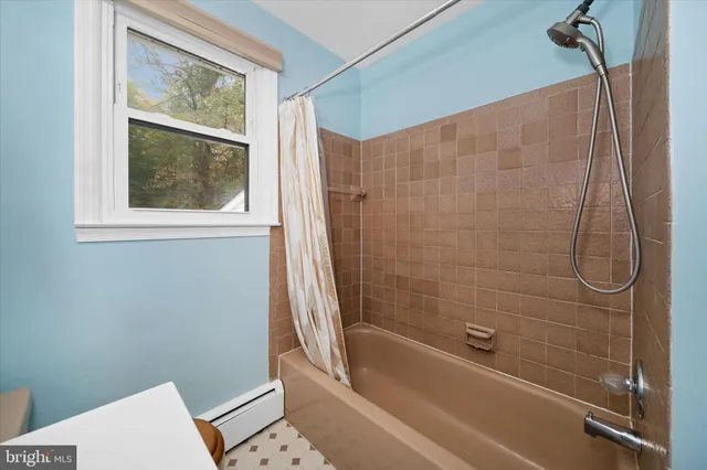 a view of an empty room with window and closet area