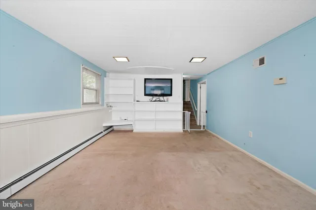 a view of empty room with a flat screen tv