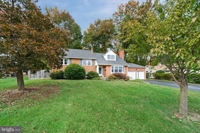 a front view of a house with yard and green space