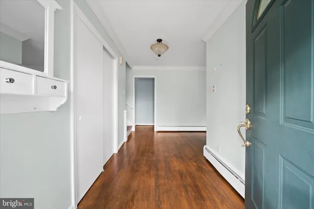 a view of a hallway with wooden floor