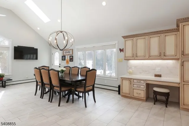 a view of bathroom with a sink mirror and window