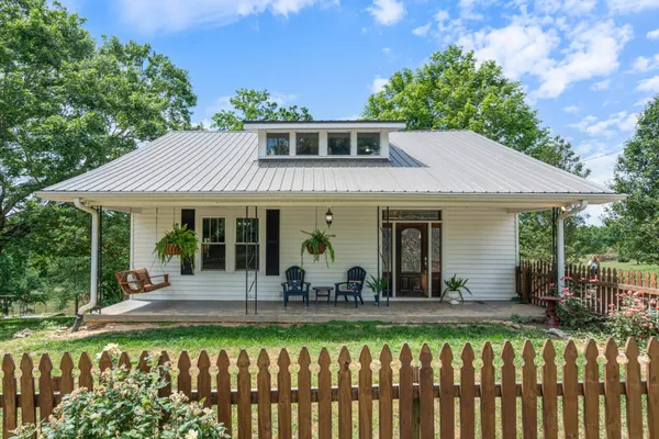 a front view of a house with a yard table and chairs