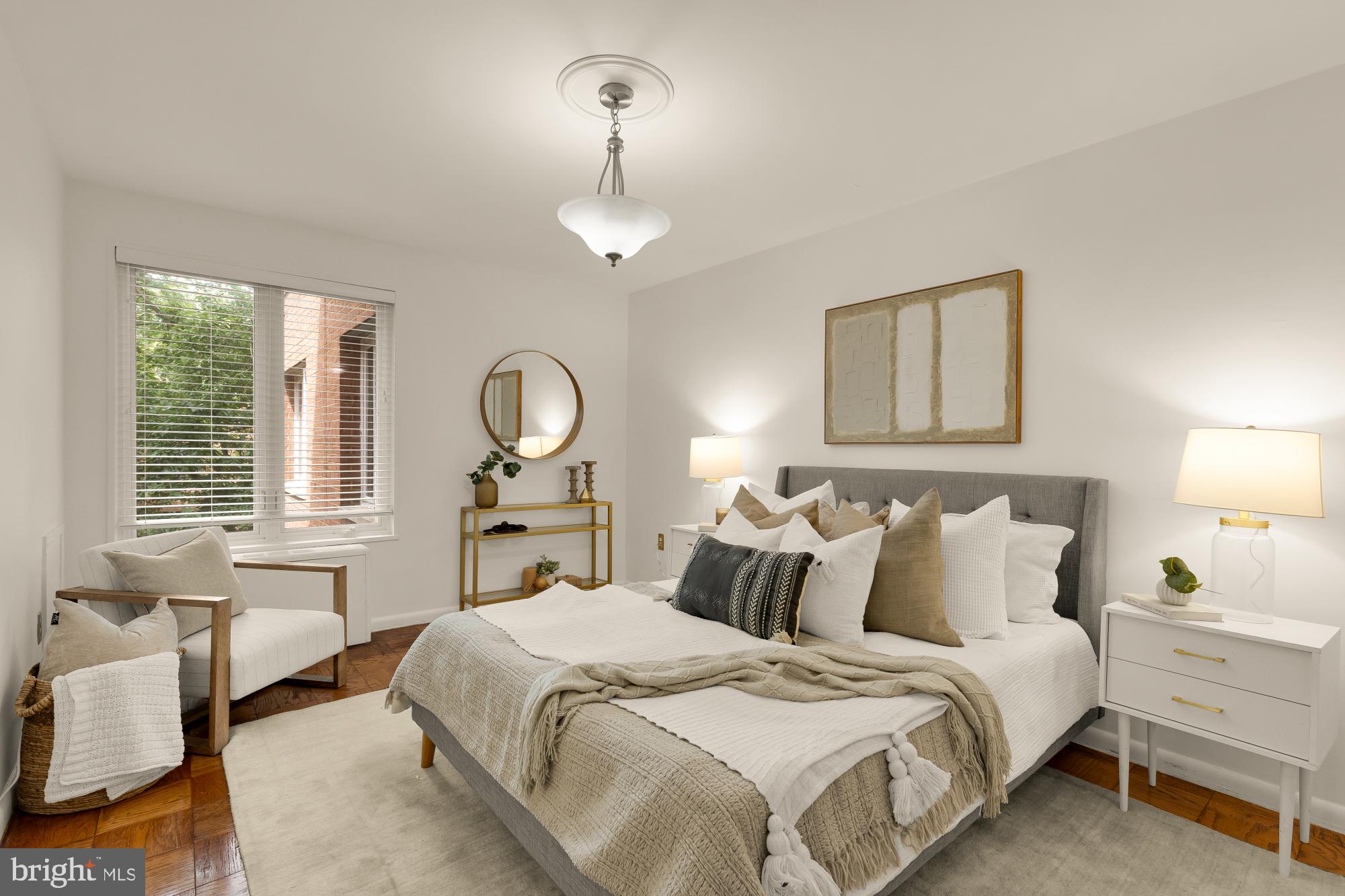 2400 41st Street Northwest, Unit 212 Washington, DC 20007 - Photo 14 of 24 a bedroom with a bed and a chandelier