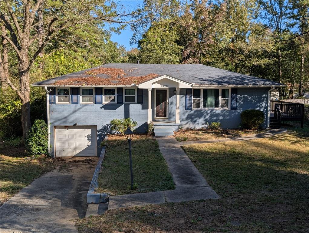 4328 Rockbridge Road Southwest Stone Mountain, GA 30083 - Photo 1 of 16 a front view of a house with garden
