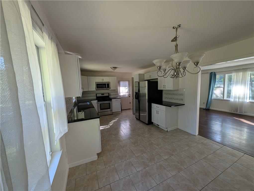 4328 Rockbridge Road Southwest Stone Mountain, GA 30083 - Photo 3 of 16 a view of a livingroom with a kitchen and furniture
