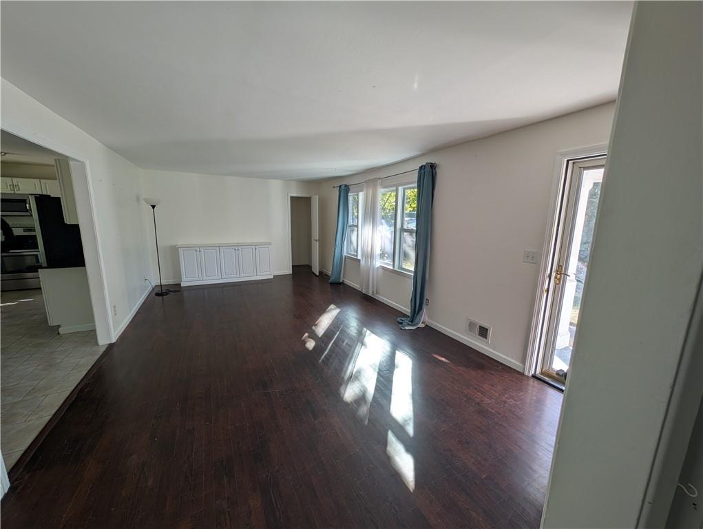 4328 Rockbridge Road Southwest Stone Mountain, GA 30083 - Photo 4 of 16 an empty room with wooden floor and windows