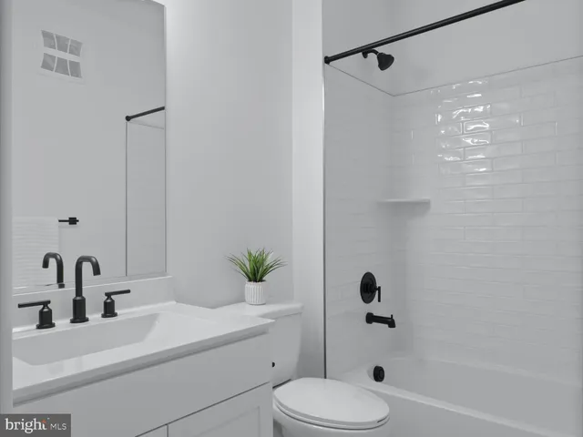 a bathroom with a sink toilet a shower and a mirror