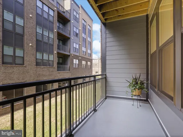 a view of a balcony with a chair and wooden floor