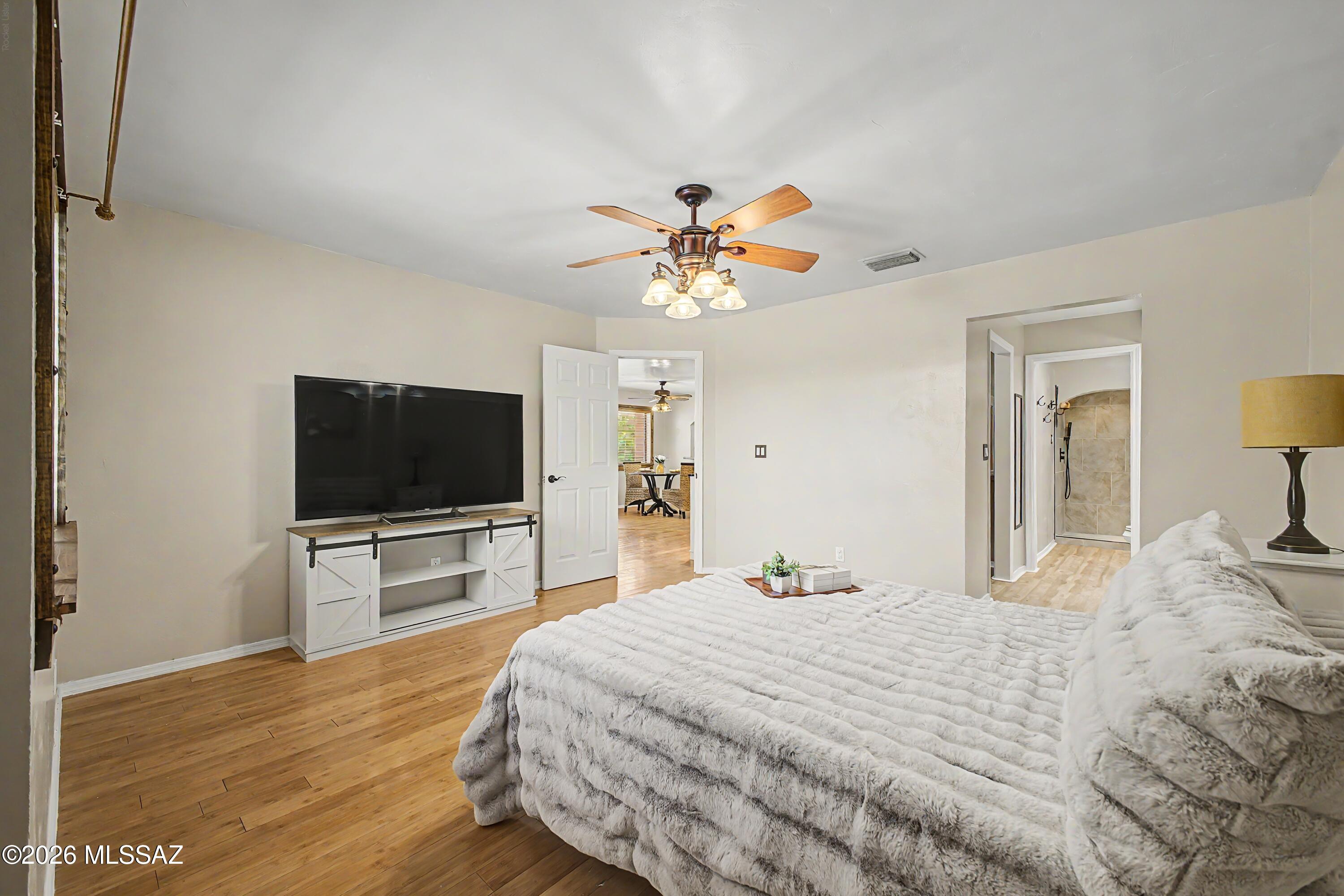 3781 East Edison Street Tucson, AZ 85716 - Photo 17 of 28 a bedroom with a bed and a flat screen tv