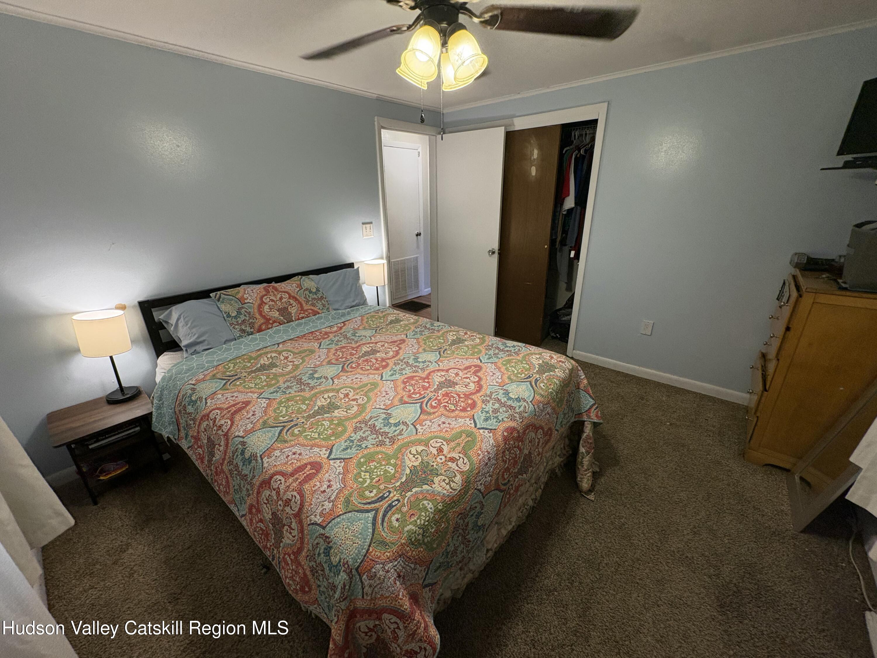 19 Rivenburg Lane Hudson, NY 12534 - Photo 12 of 28 a bed sitting in a bedroom next to a lamp