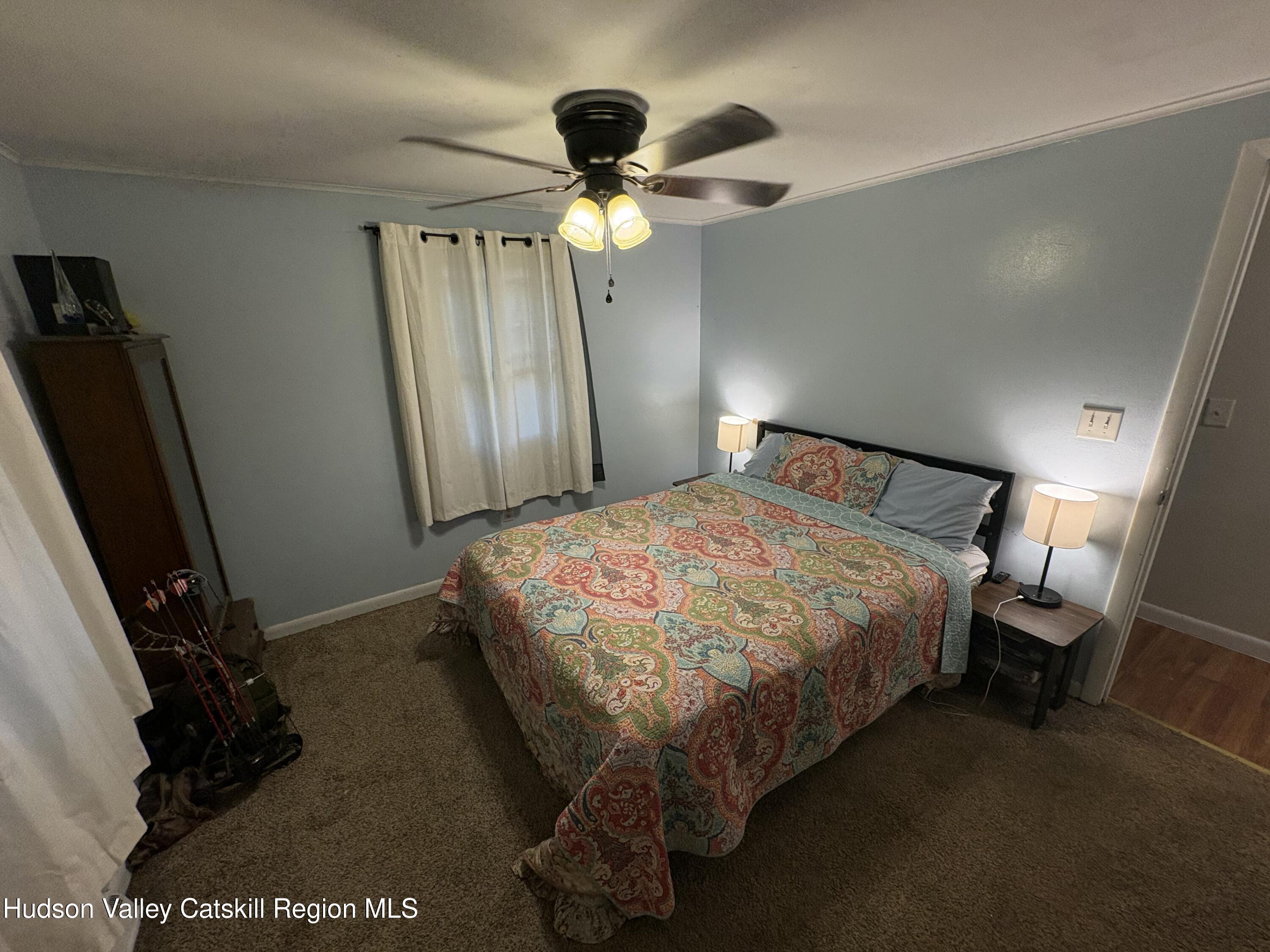 19 Rivenburg Lane Hudson, NY 12534 - Photo 13 of 28 a bedroom with a bed and a chandelier