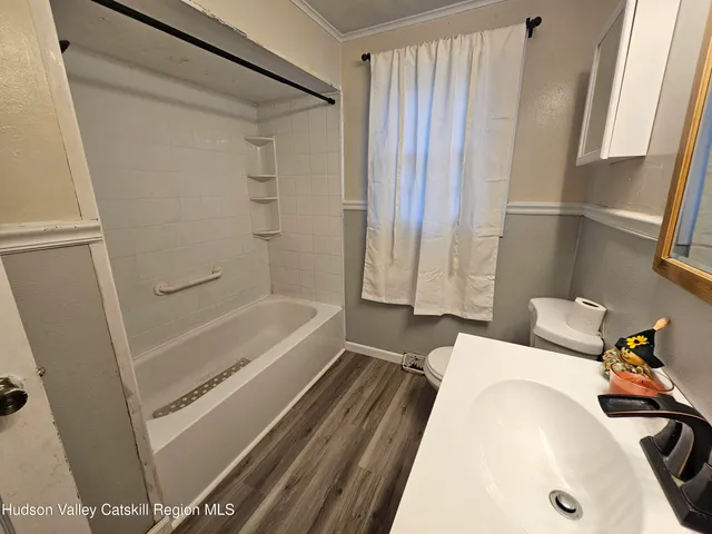 a bathroom with a tub and a shower