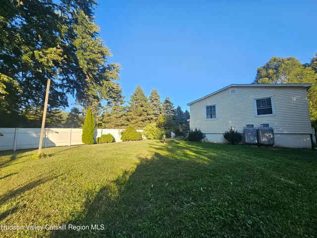 a view of a house with a backyard
