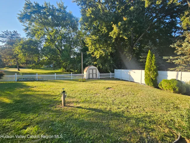 a swimming pool with trees in the background