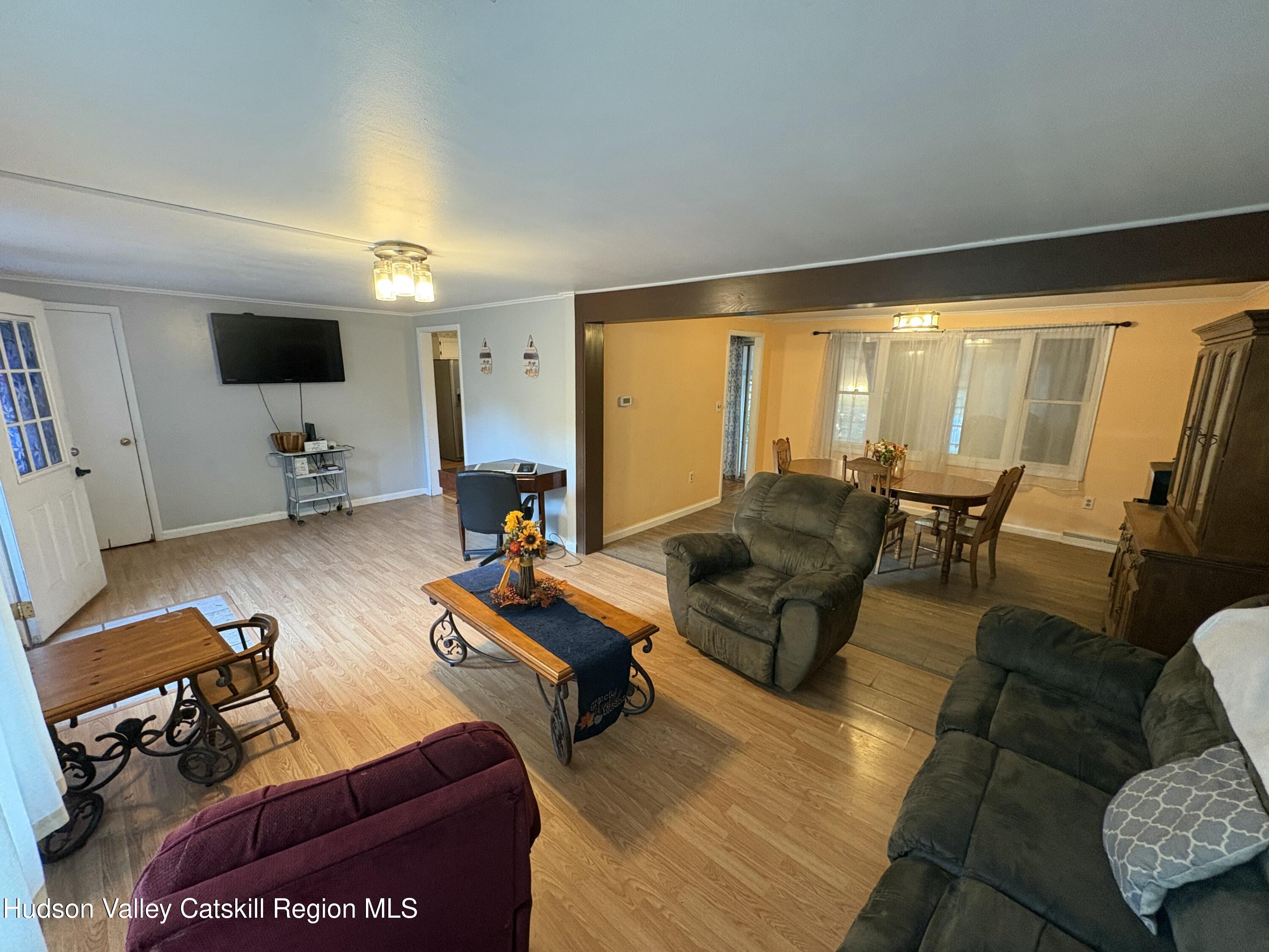 19 Rivenburg Lane Hudson, NY 12534 - Photo 4 of 28 a living room with furniture and a flat screen tv