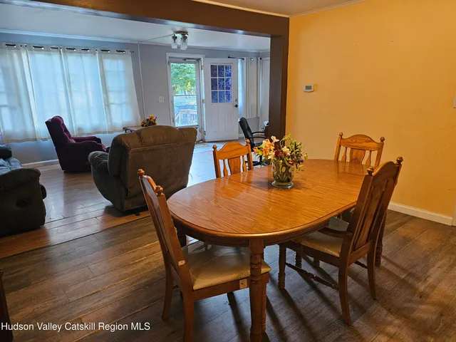 a view of a dining room with furniture and window
