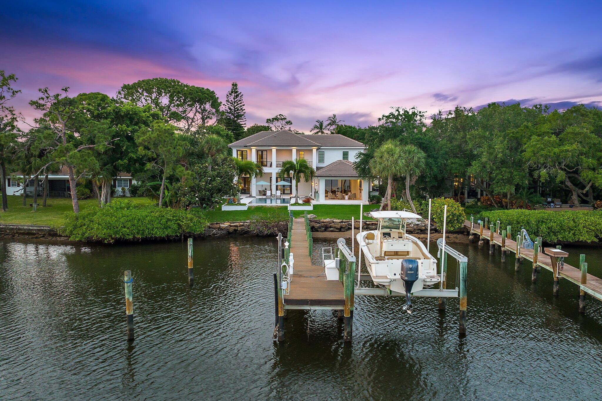 19651 North Riverside Drive Jupiter, FL 33469 - Photo 1 of 96 a view of a lake with a table and chairs