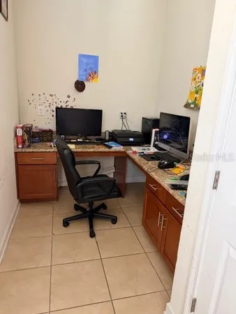 a workspace with furniture and flat screen tv