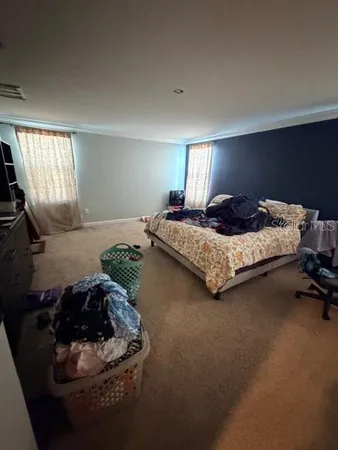a bedroom with a bed and dresser