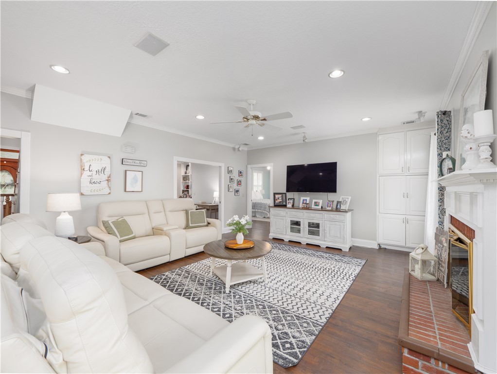 202 Chesser Lane Folkston, GA 31537 - Photo 10 of 76 Spacious family room featuring surround sound, a gas fireplace, and built-in shelving