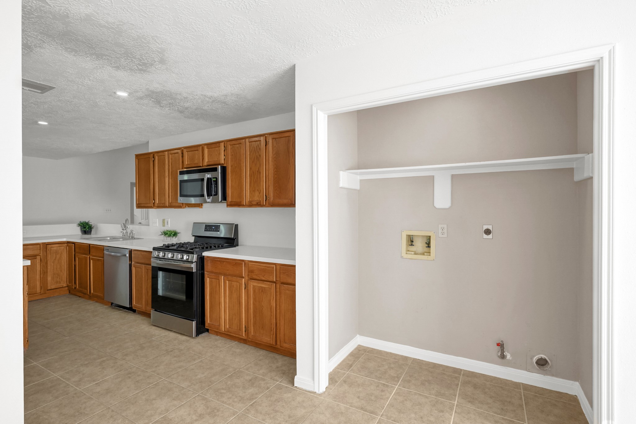 3406 Hartfield Lane Spring, TX 77388 - Photo 13 of 44 a kitchen with stainless steel appliances granite countertop a refrigerator and a stove top oven