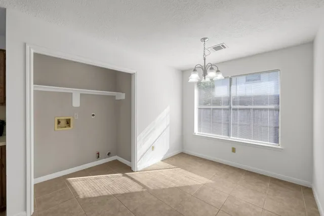 a view of empty room with ceiling fan