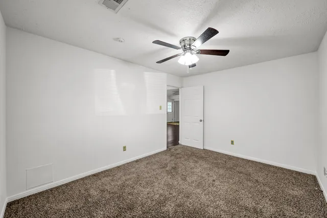 a view of a balcony with two chairs and a wooden floor