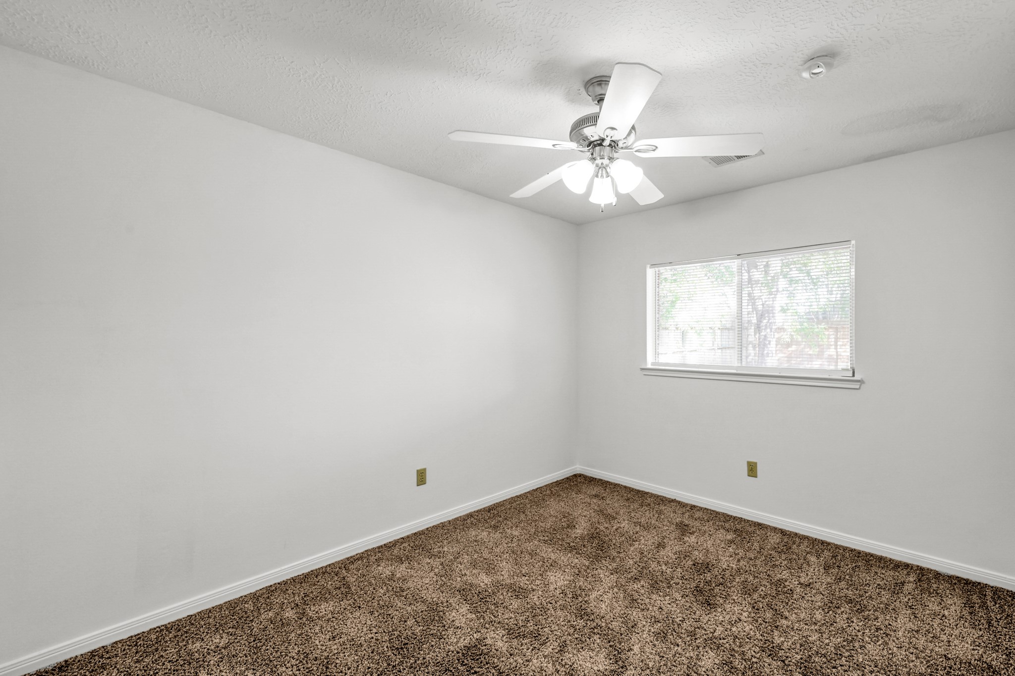 3406 Hartfield Lane Spring, TX 77388 - Photo 26 of 44 an empty room with a window and a fan