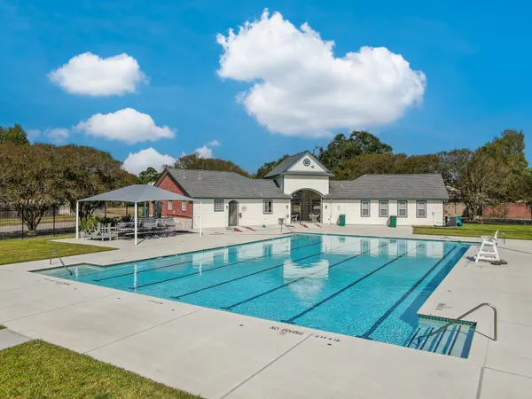 a view of a house with swimming pool and view of a lake
