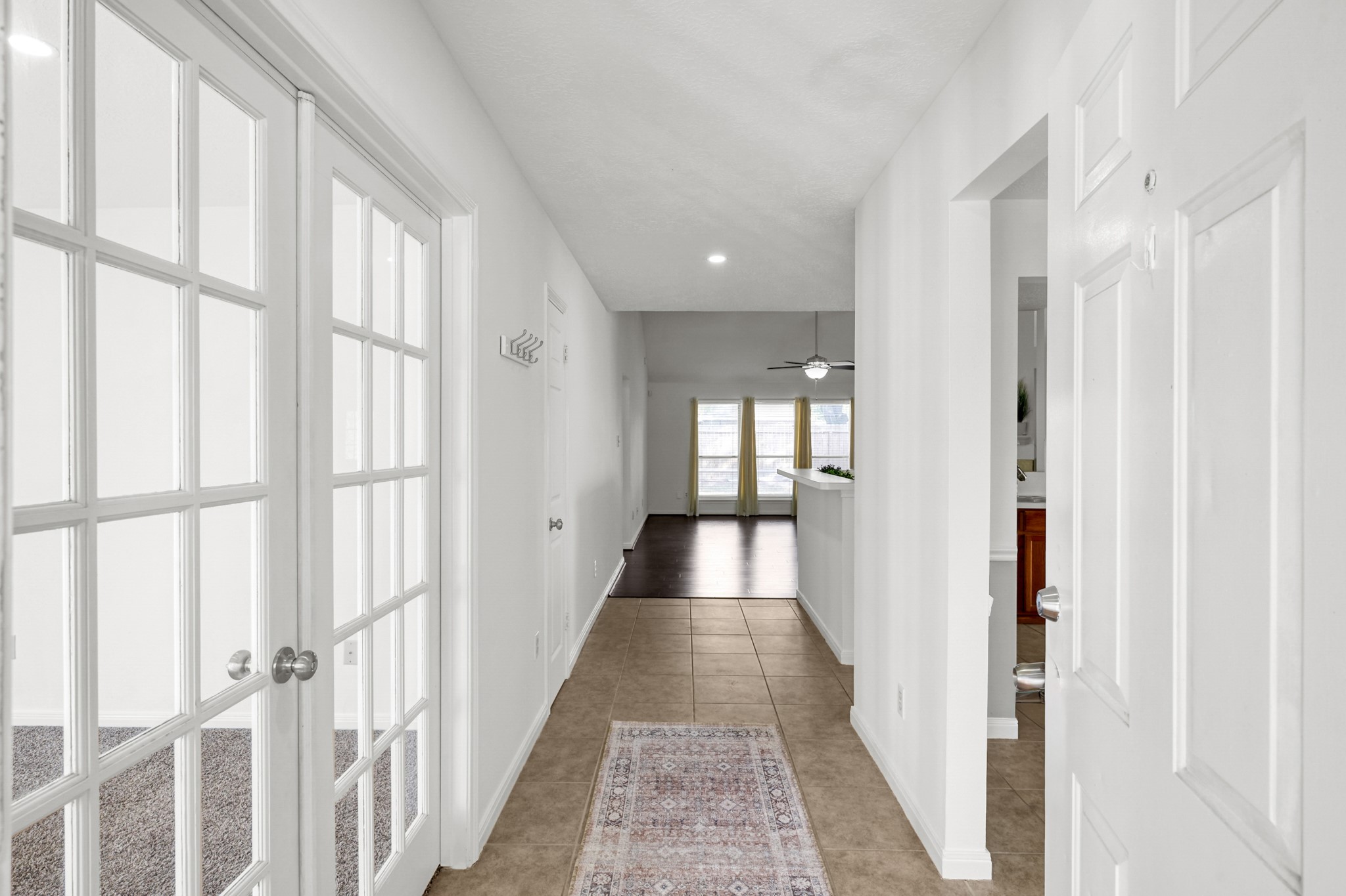3406 Hartfield Lane Spring, TX 77388 - Photo 4 of 44 a view of a hallway with wooden floor and windows