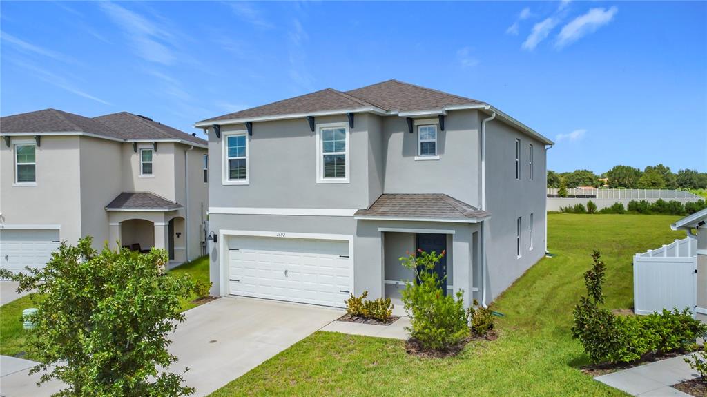 2692 Reddish Egret Bend, Unit 1 St. Cloud, FL 34773 - Photo 1 of 30 a front view of a house with garden