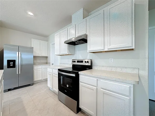 a kitchen with a stove and a refrigerator