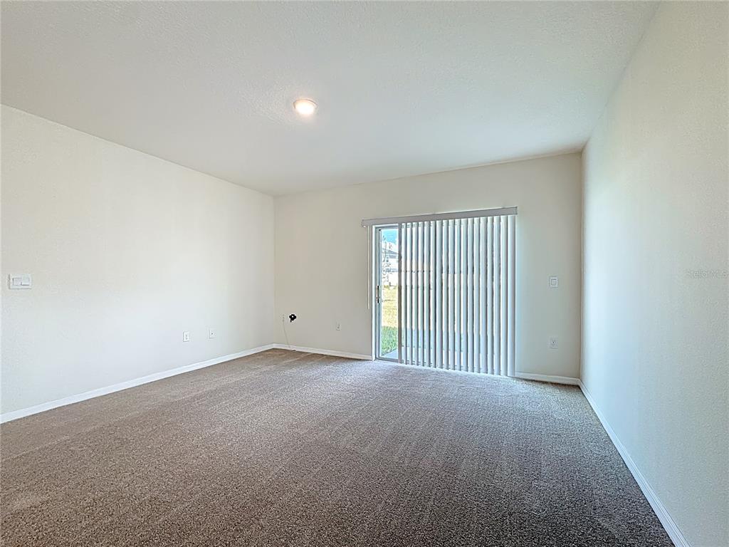 2692 Reddish Egret Bend, Unit 1 St. Cloud, FL 34773 - Photo 19 of 30 a view of an empty room with a window