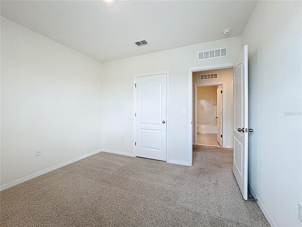 2692 Reddish Egret Bend, Unit 1 St. Cloud, FL 34773 - Photo 25 of 30 an empty room with closet area