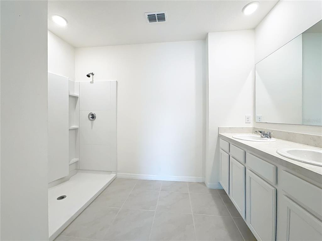 2692 Reddish Egret Bend, Unit 1 St. Cloud, FL 34773 - Photo 28 of 30 a bathroom with a sink and a shower