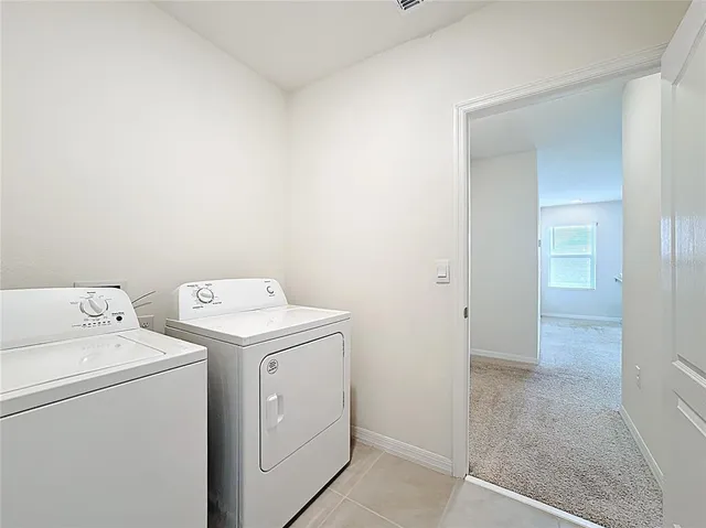 a utility room with dryer and washer