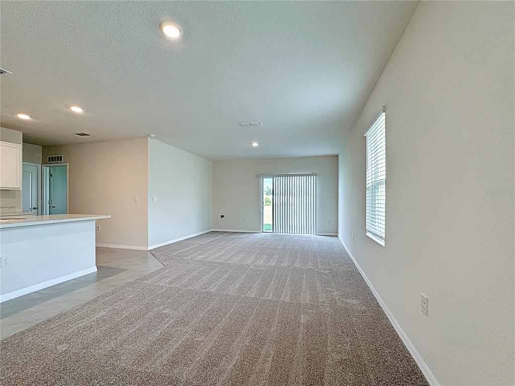 2692 Reddish Egret Bend, Unit 1 St. Cloud, FL 34773 - Photo 3 of 30 an empty room with windows and entrance