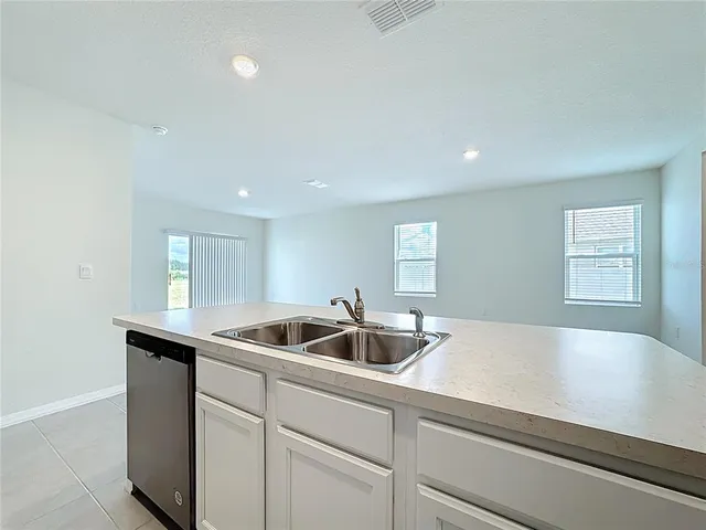 a kitchen with kitchen island a sink and refrigerator