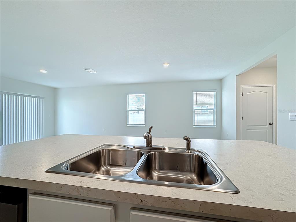 2692 Reddish Egret Bend, Unit 1 St. Cloud, FL 34773 - Photo 9 of 30 a kitchen with a sink and cabinets