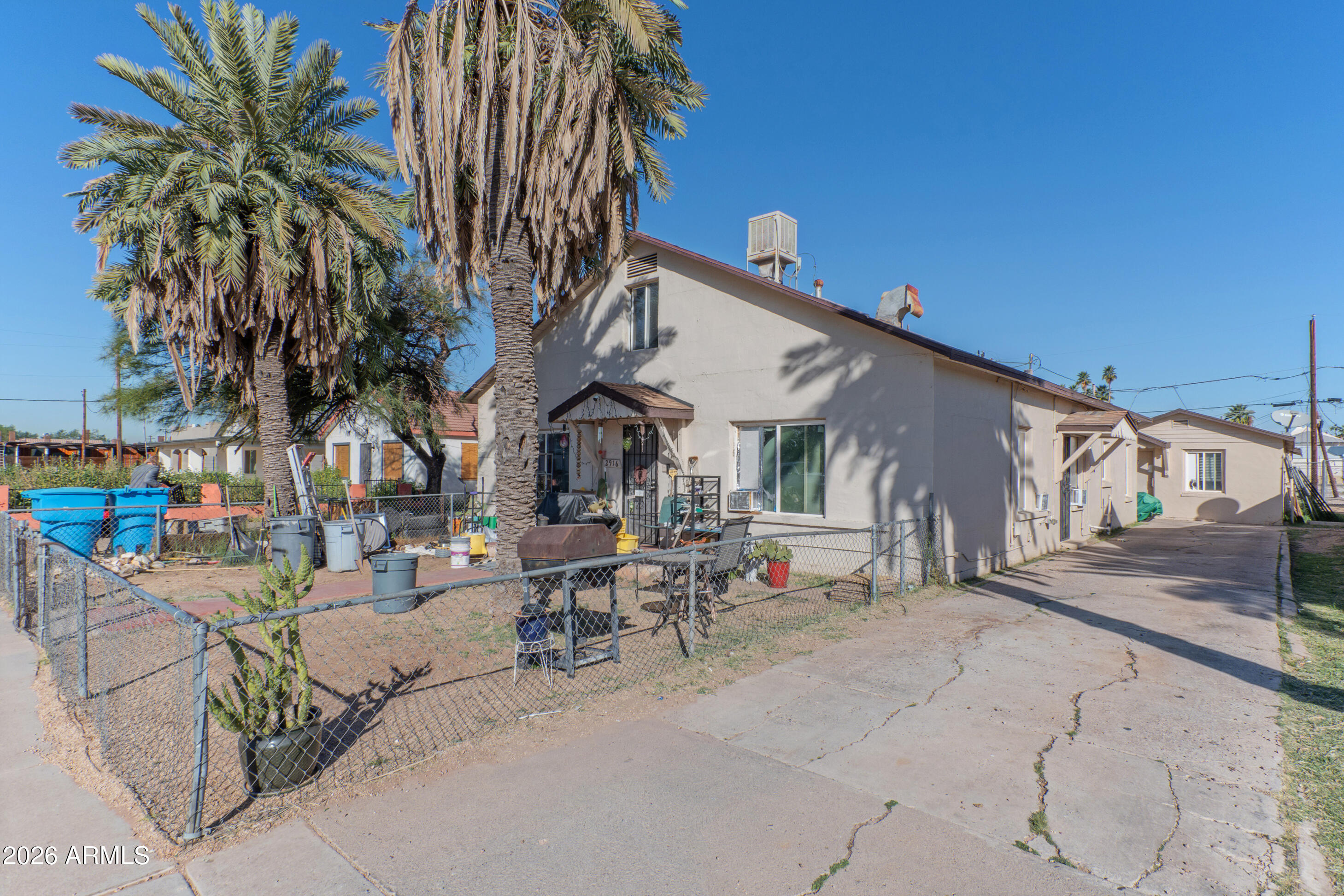 2916 East Monroe Street Phoenix, AZ 85034 - Photo 10 of 11 a row of palm trees in front of house