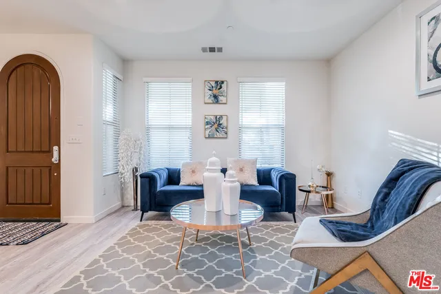 a living room with fireplace furniture and a window