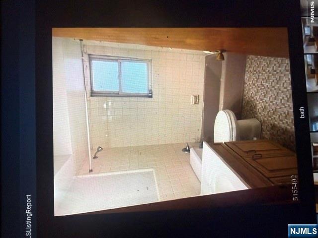 490 Union Avenue Rutherford, NJ 07070 - Photo 5 of 11 a bathroom with a granite countertop sink toilet and shower