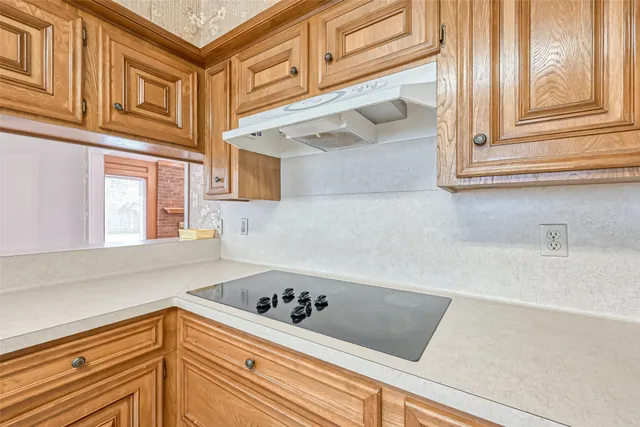 a kitchen with a sink cabinets and window