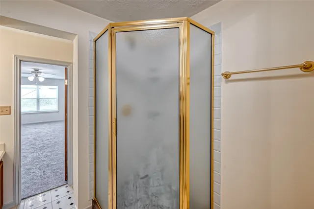 a bathroom with a glass door shower and a sink